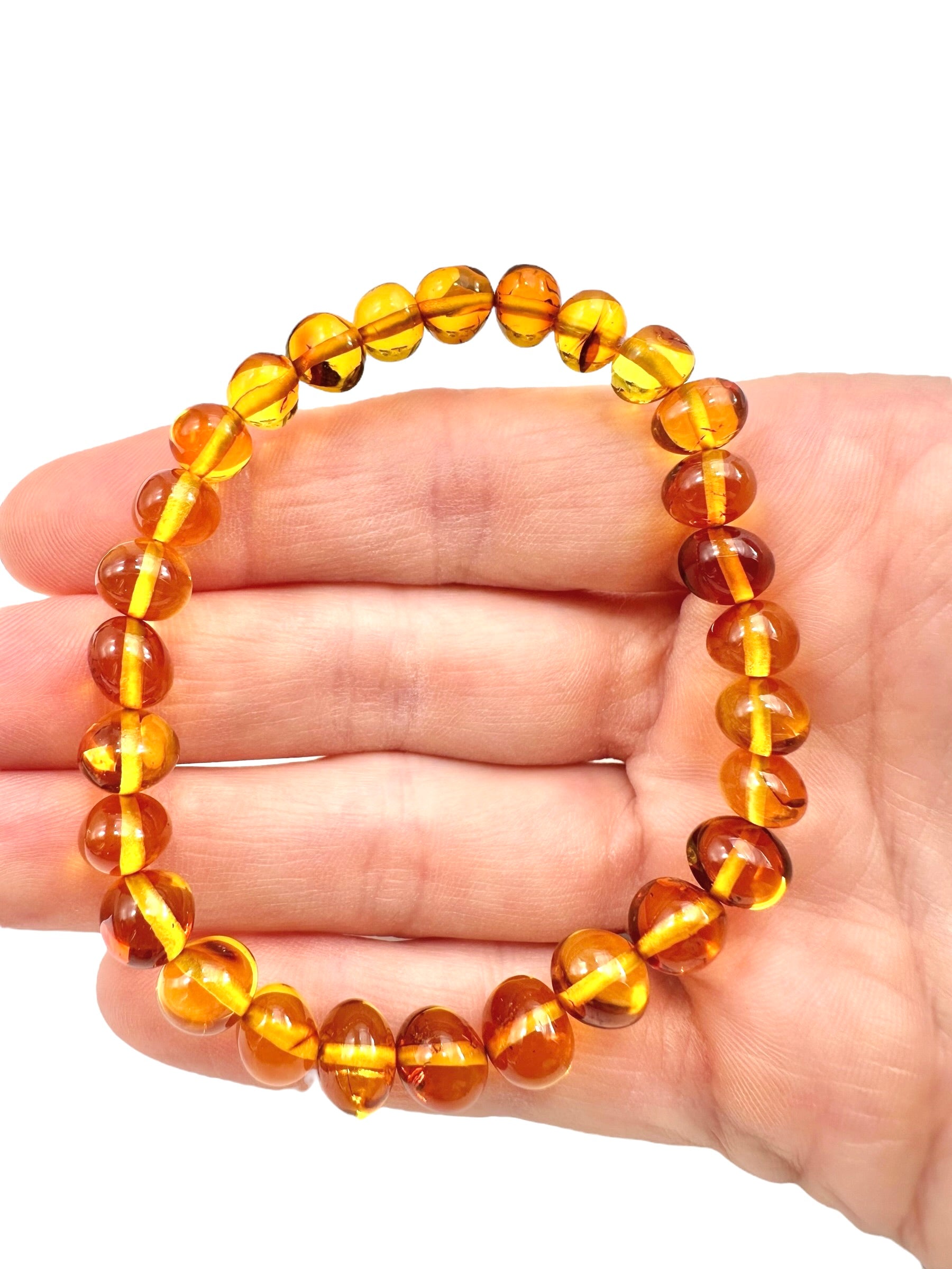 Bracelet made of polished genuine amber beads / light – random piece