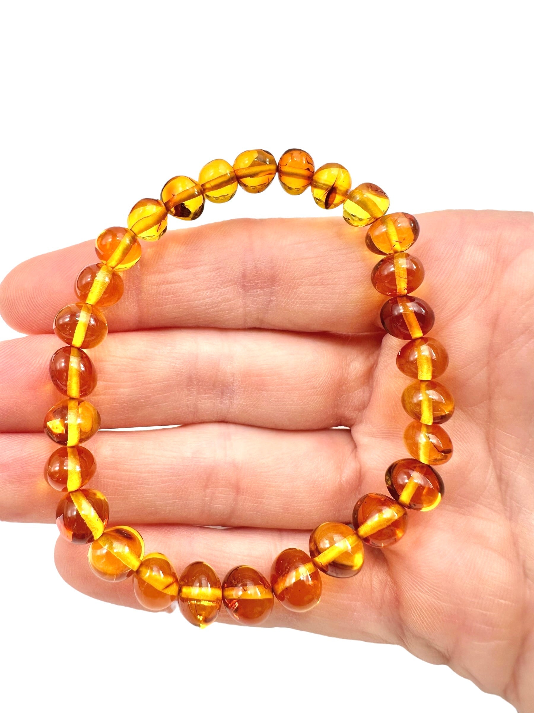 Bracelet made of polished genuine amber beads / light – random piece