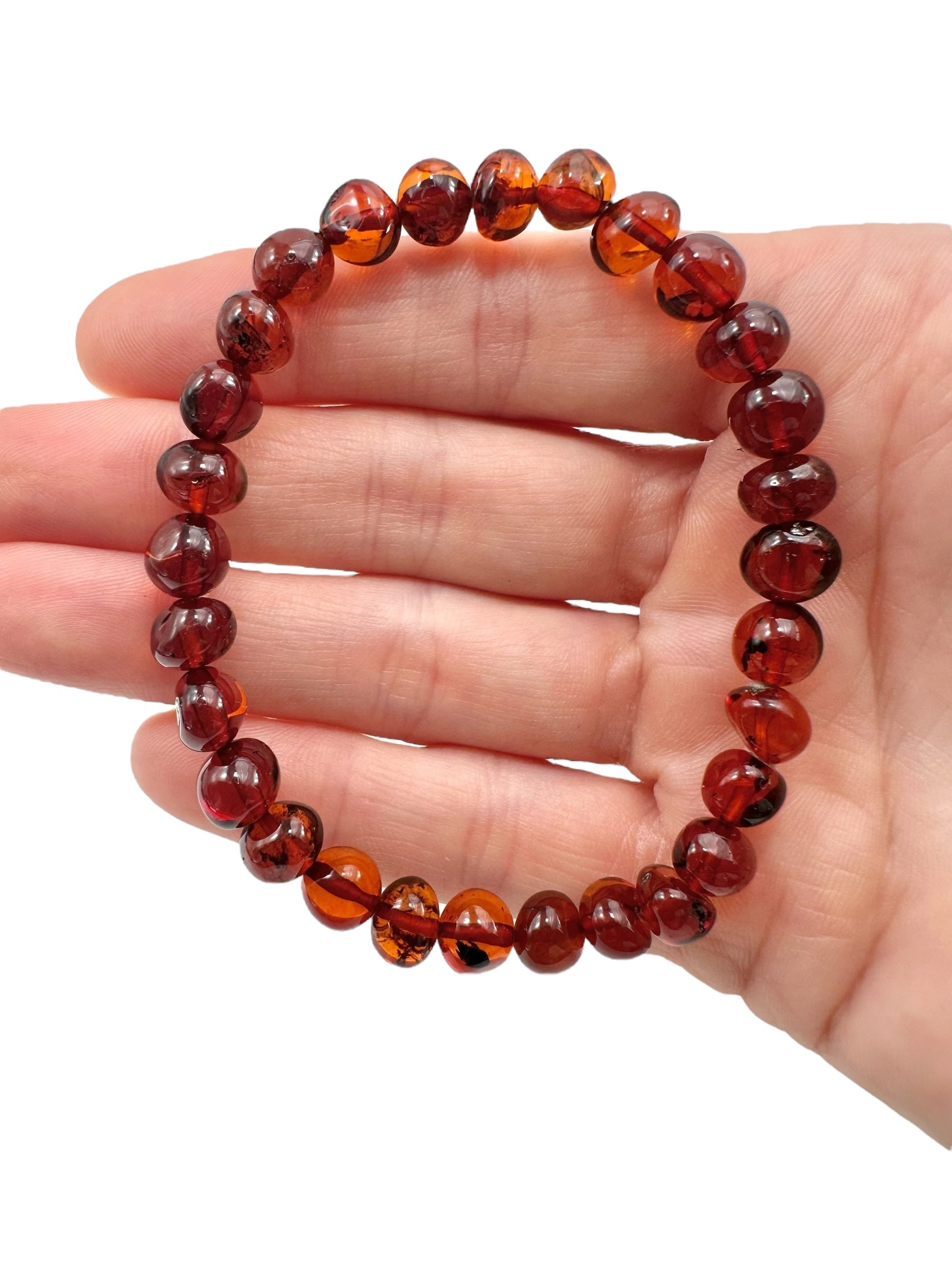 Bracelet made of polished genuine amber beads / dark – random piece