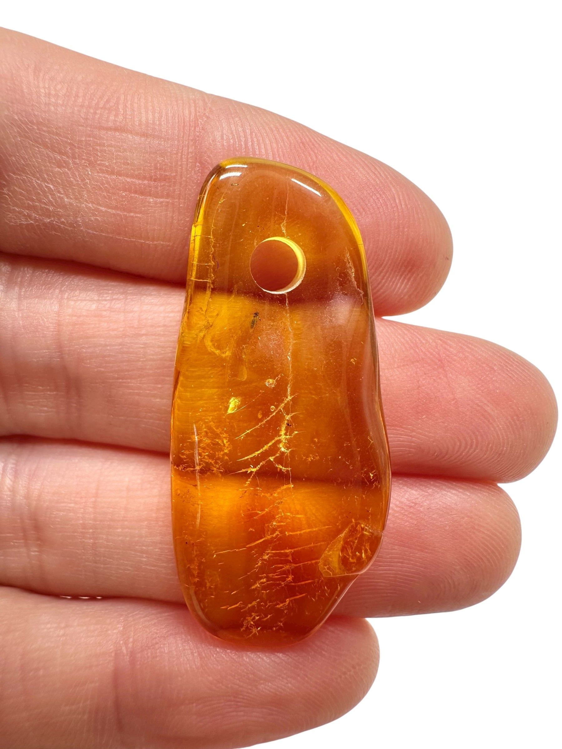 Amber with a drilled hole for hanging 1,7g – Lithuania