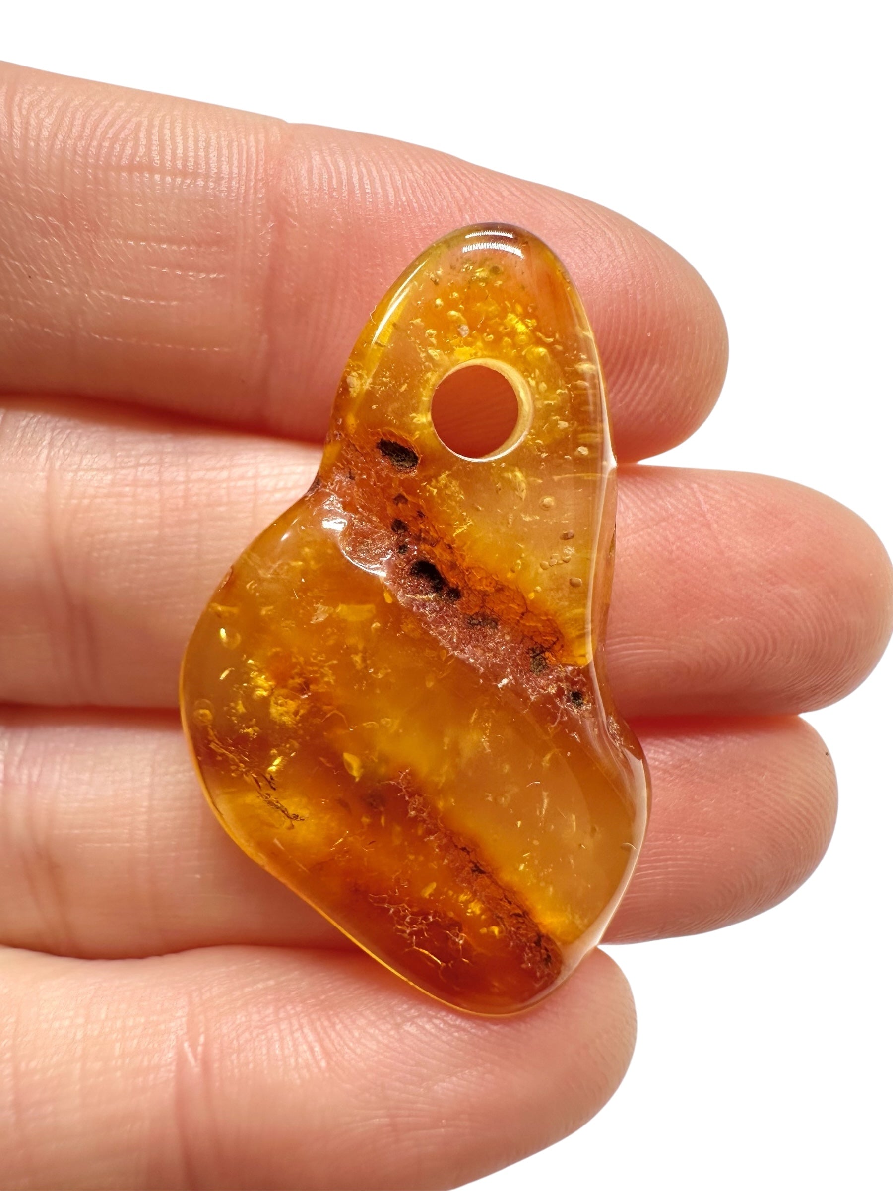 Amber with a drilled hole for hanging 2,3g – Lithuania