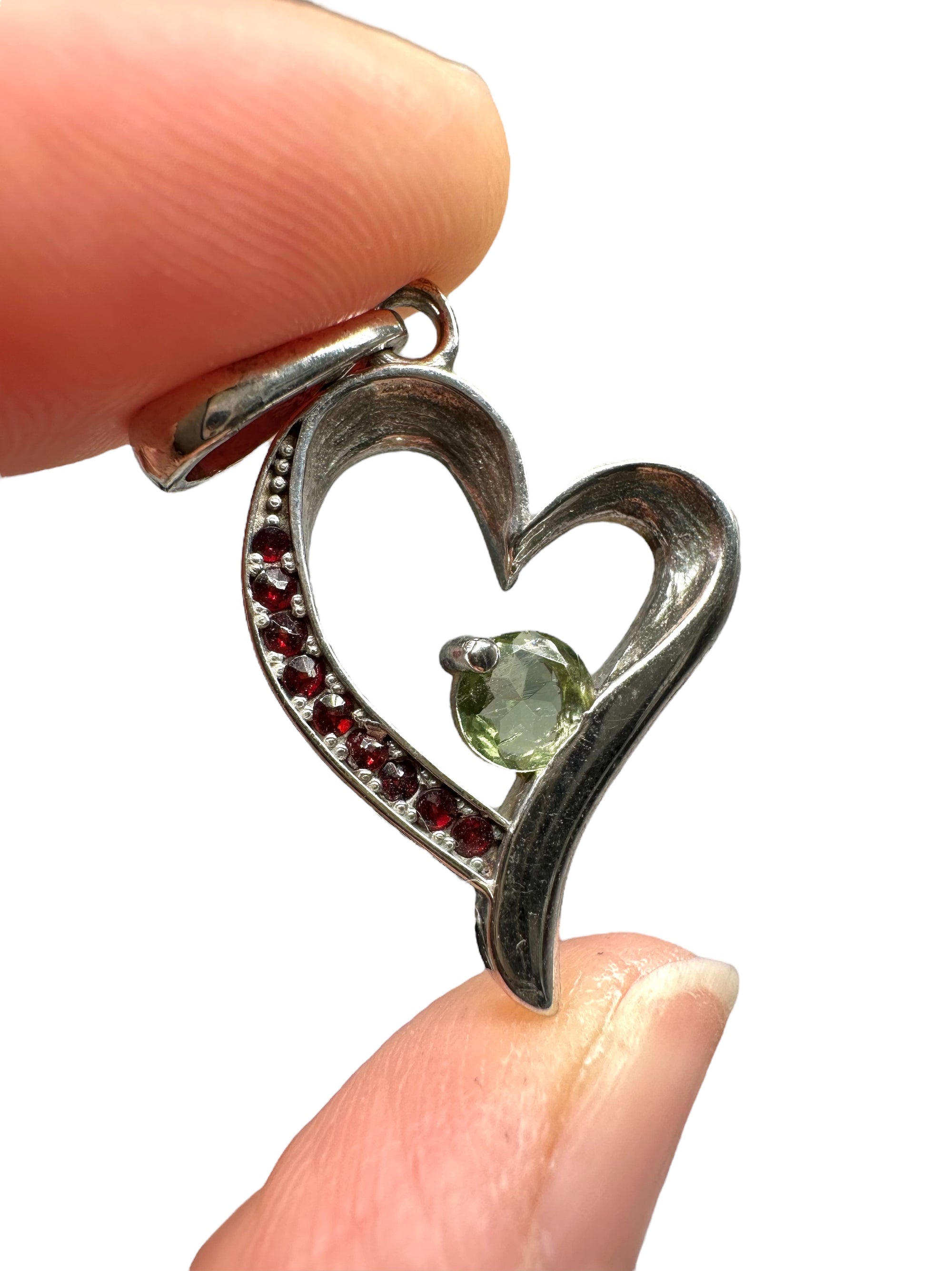Silver heart-shaped pendant with faceted moldavite and Czech garnets