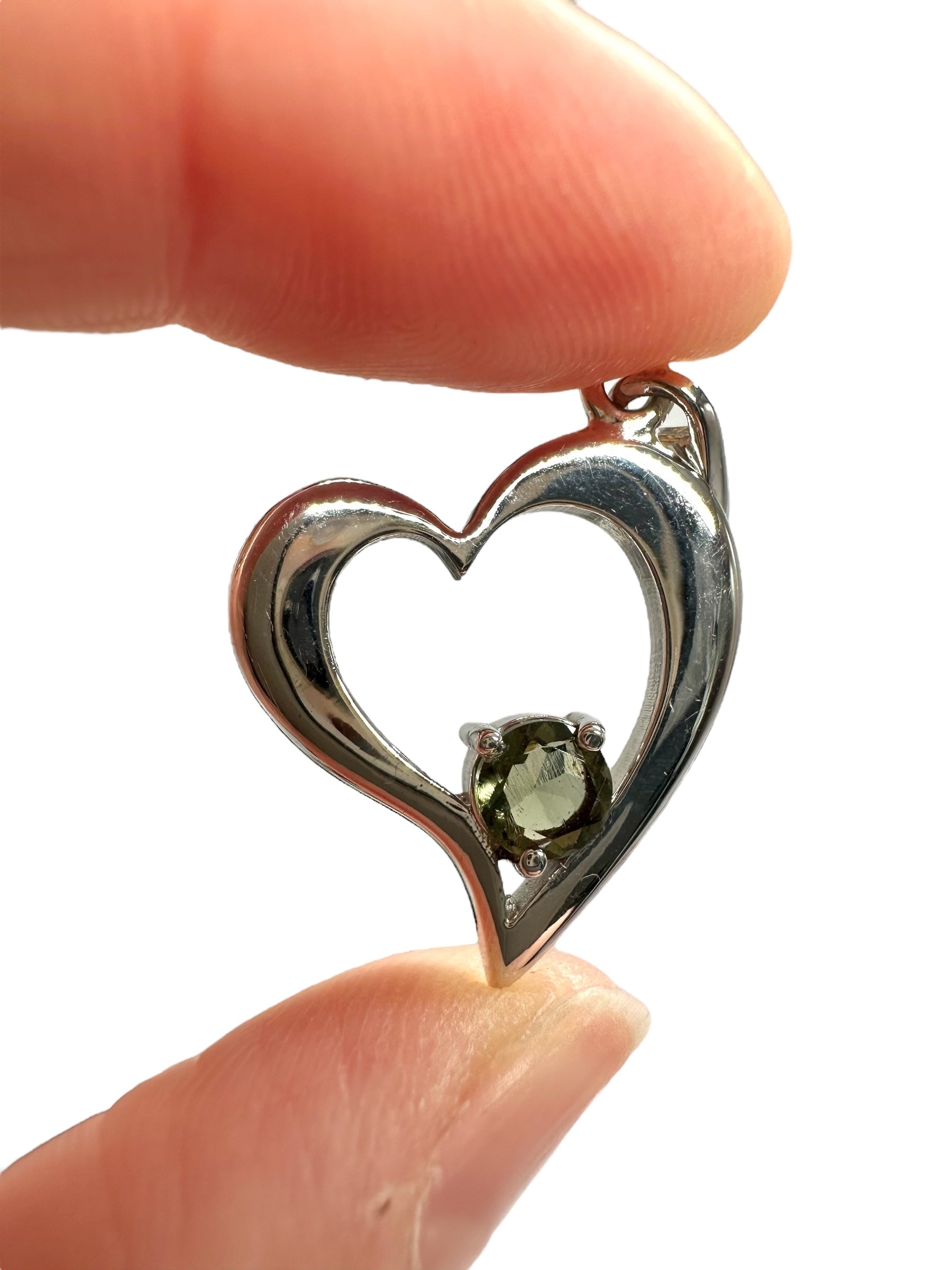 Silver heart-shaped pendant with faceted moldavite