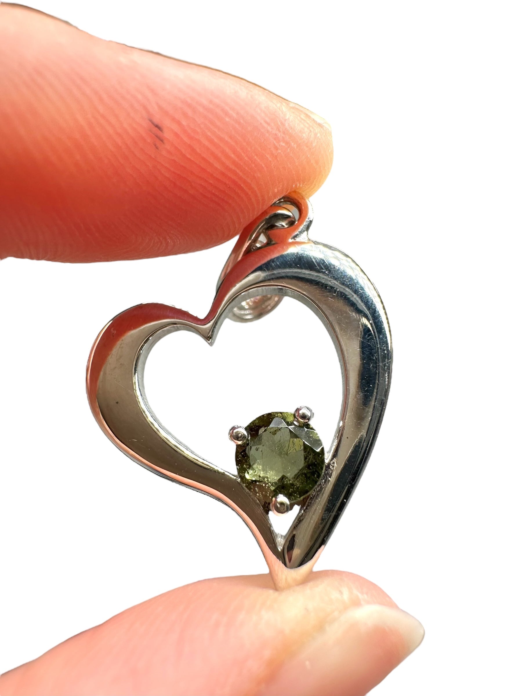 Silver heart-shaped pendant with faceted moldavite