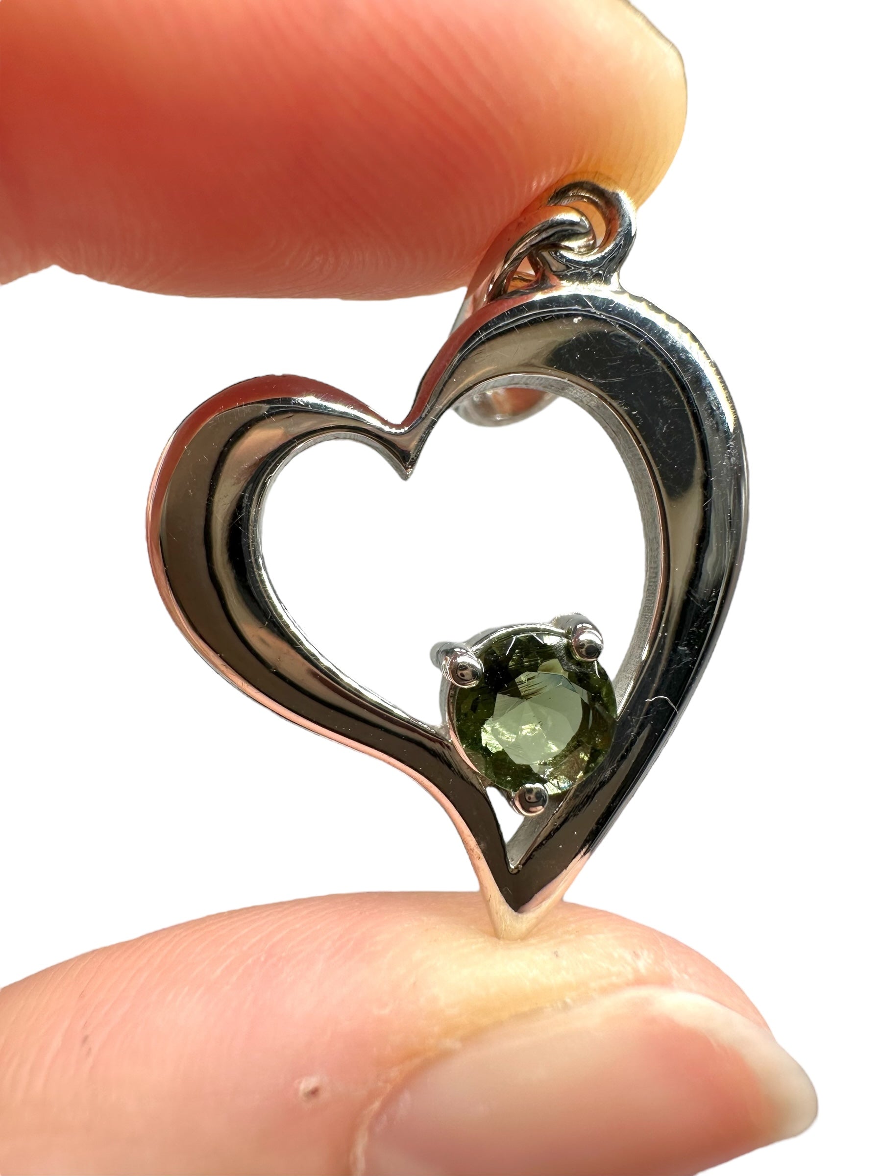 Silver heart-shaped pendant with faceted moldavite