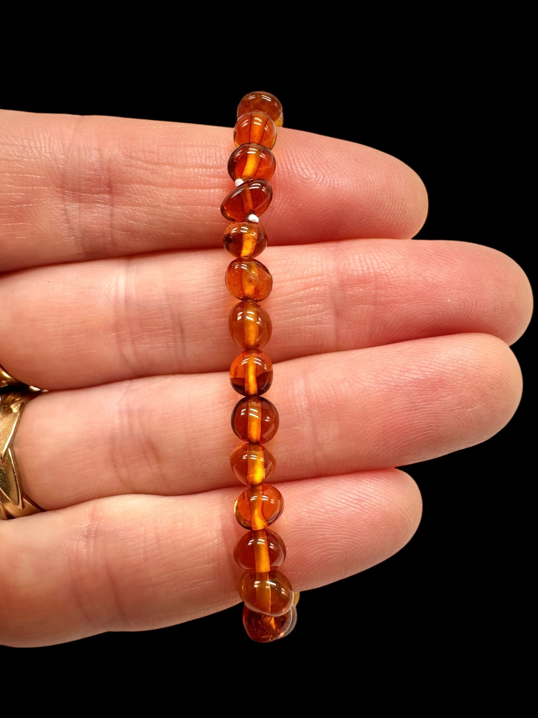 Children's bracelet made of polished genuine amber spheres / dark – random piece - N/J024