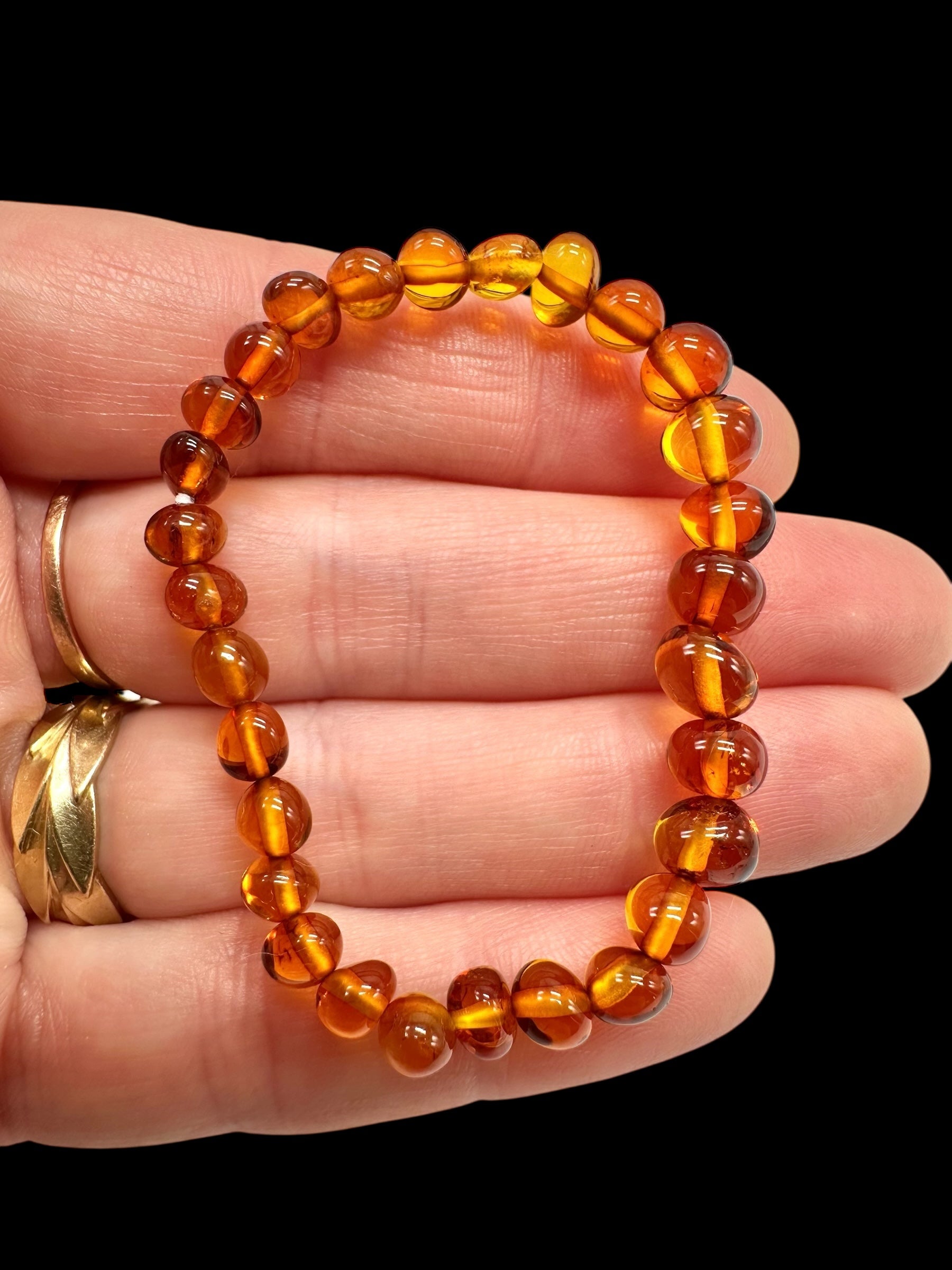 Children's bracelet made of polished genuine amber spheres / dark – random piece