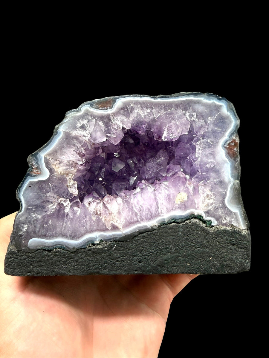 Geode di ametista grezza del Brasile con cristalli violetti e bordo di calcedonio bianco