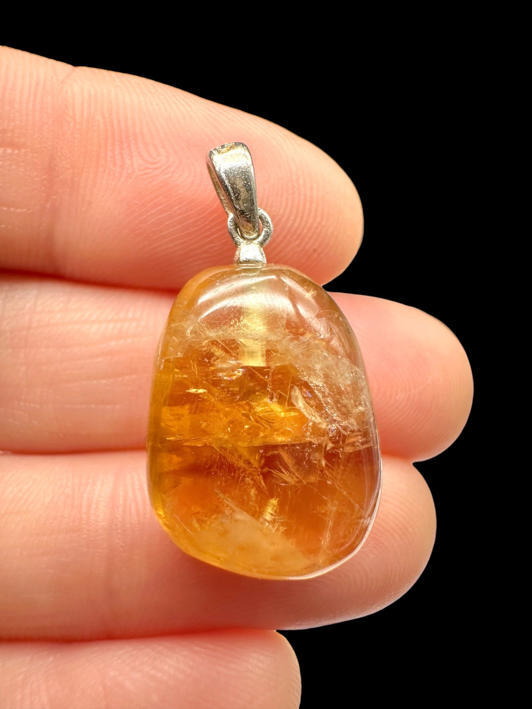 Silver pendant made of honey calcite