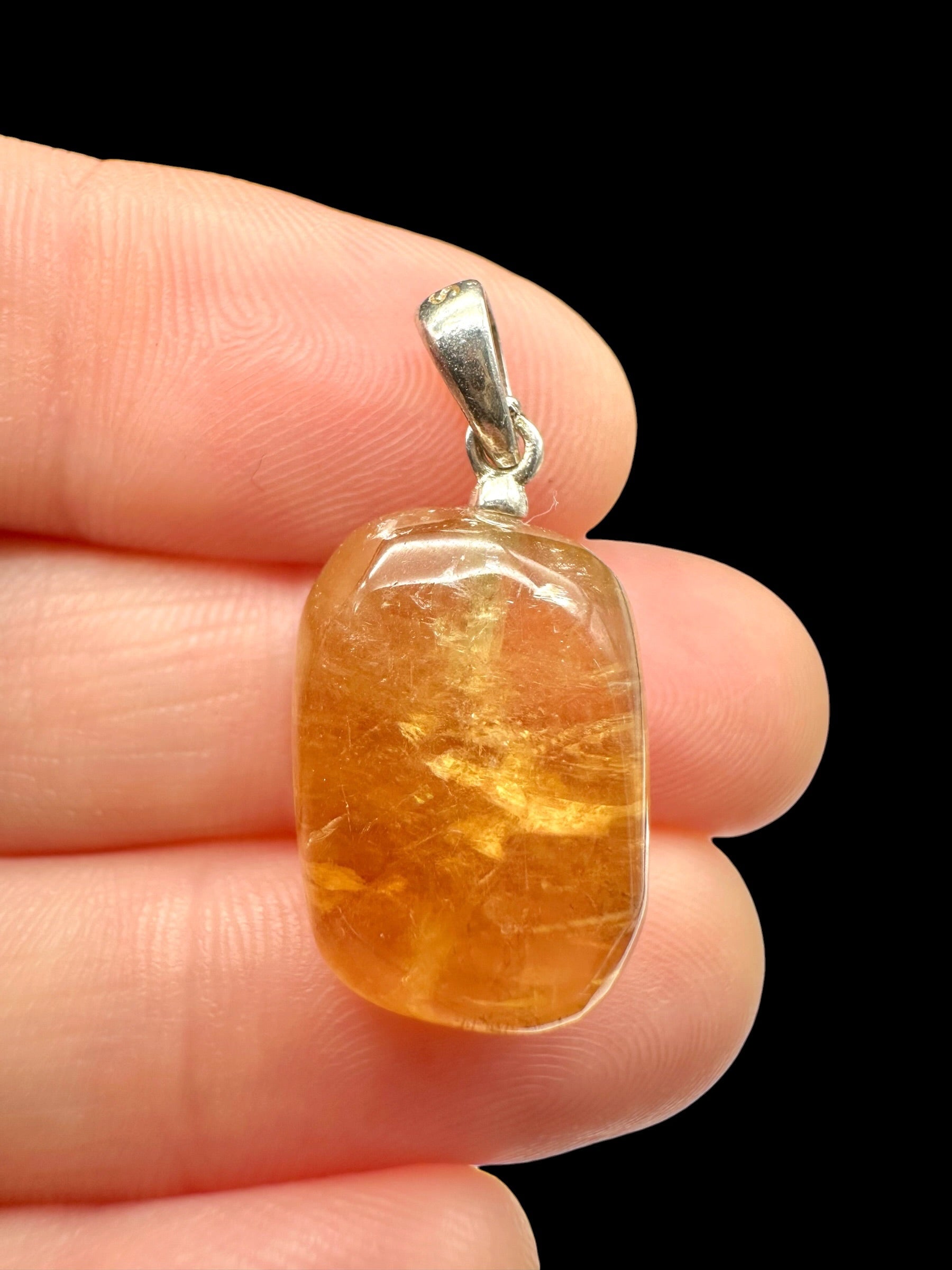 Silver pendant made of honey calcite