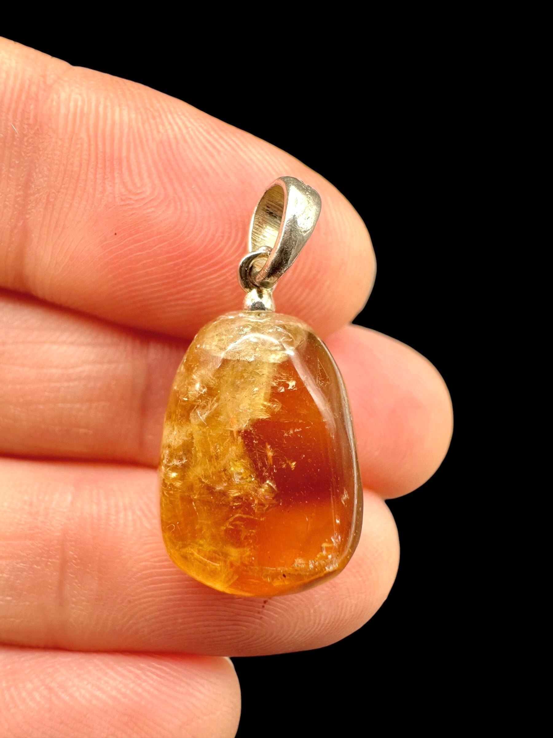 Silver pendant made of honey calcite