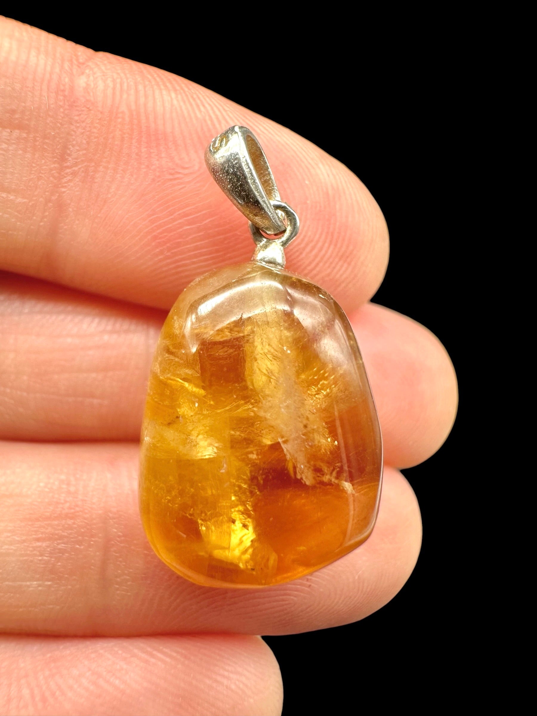 Silver pendant made of honey calcite