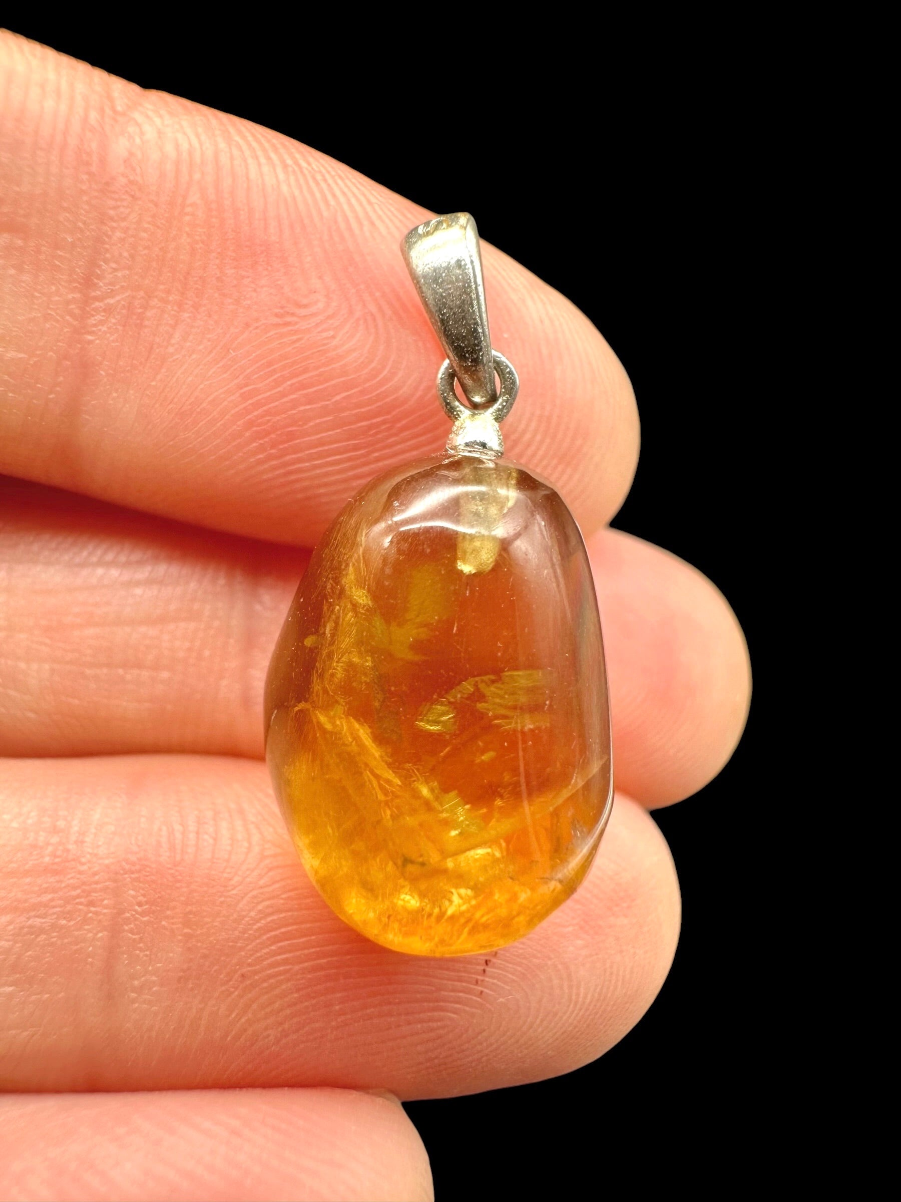 Silver pendant made of honey calcite