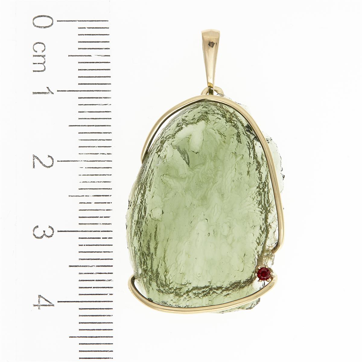 Golden pendant with a moldavite and garnet 1767-2